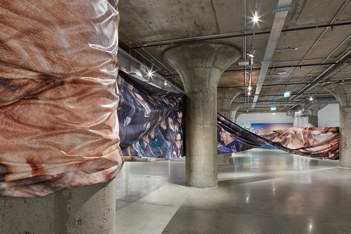 Satoshi Fujiwara, *[Crowd Landscape](\artworks\b44068d8-adee-4bb9-a1ac-08deaa6b6cd5)*, installation view in *[Age of You](\exhibitions\4a33cf67-5500-4ca2-0ca2-08dea67600b7)*, [Museum of Contemporary Art Toronto](\institutions\512e535f-b791-4854-0fd2-08dea687d3be), Toronto, 2019. Co-curated by [Shumon Basar](\people\07f15411-8746-48de-5bf2-08deaa62a1f3), [Douglas Coupland](\people\f99e3d0b-fb12-4d93-a9b1-08de3f2b66d8), and [Hans Ulrich Obrist](\people\c0abd490-8053-4334-f75a-08de041df6f5).