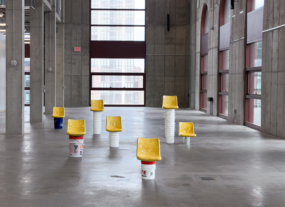 Abed Elmajid Shalabi, *[Seven Seats and as Many Buckets As It Takes To Build a Stadium](\artworks\3f7197a5-621c-47ab-898d-08de3e80e79c)* (2025). Installation view, [Powerhouse Arts](\institutions\53e11d46-e7a8-4ffc-b115-08dec05505dd), Brooklyn, NY, 2025.